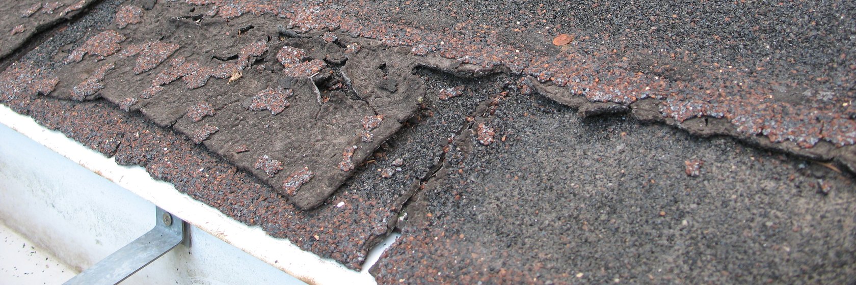 Roof Repair in Kyle - Damaged roof shingles needing repair