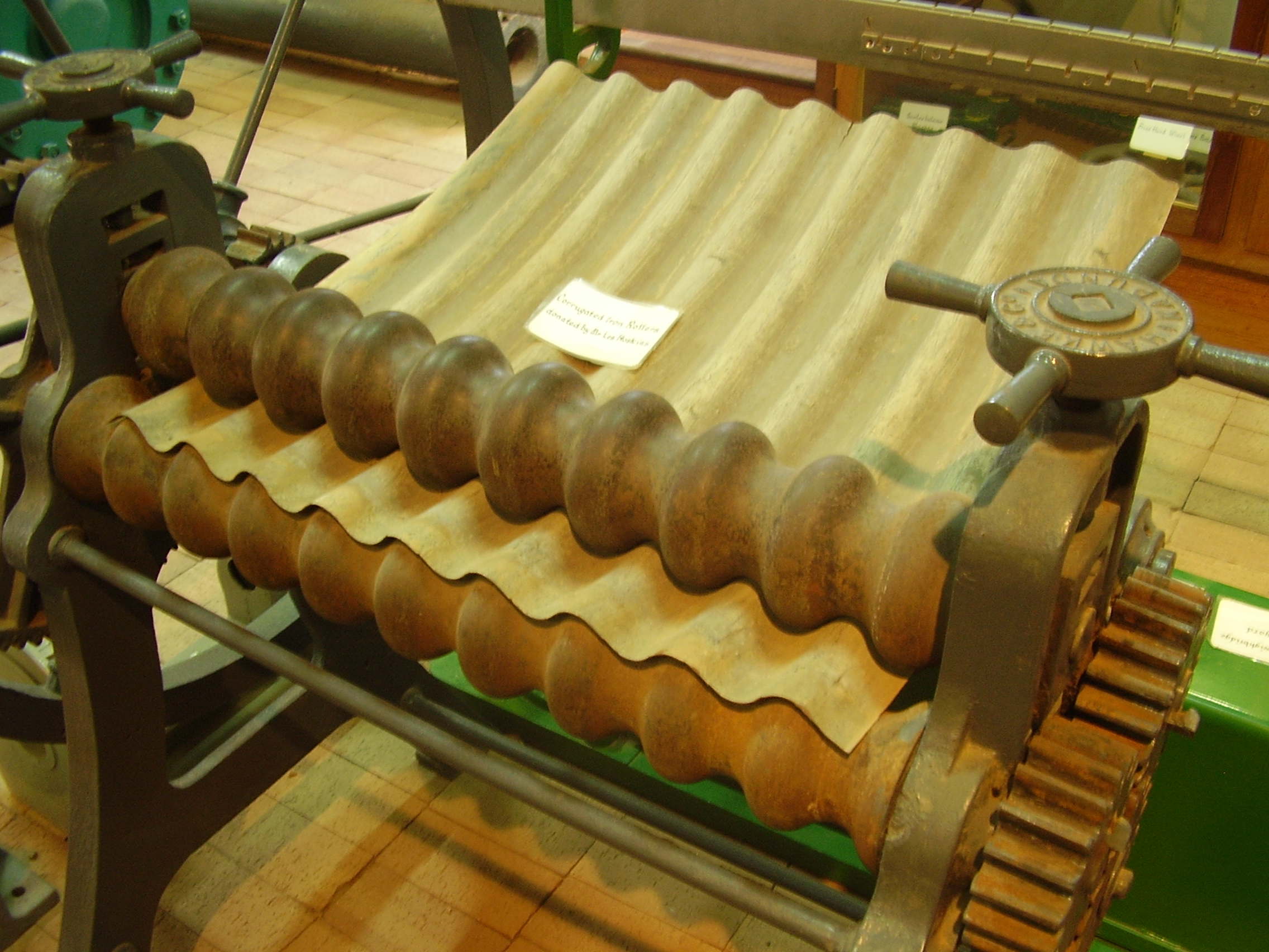 Corrugated metal roofing material